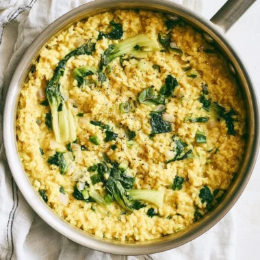 Bowl of anti-inflammatory creamy coconut rice garnished with herbs