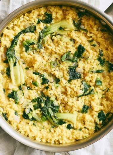 Bowl of anti-inflammatory creamy coconut rice garnished with herbs