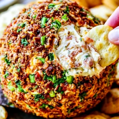 Bacon Ranch Cheese Ball appetizer with garnishes on a platter