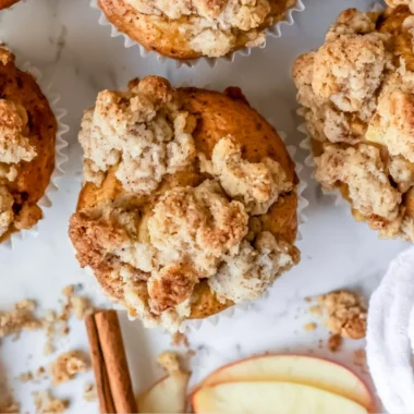 Freshly baked cozy apple crumble muffins with a golden crumble topping