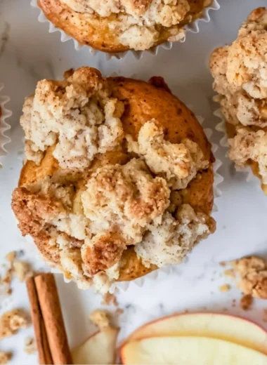 Freshly baked cozy apple crumble muffins with a golden crumble topping