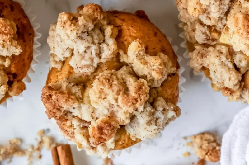 Freshly baked cozy apple crumble muffins with a golden crumble topping