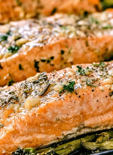 Cozy garlic butter baked salmon on a plate garnished with herbs
