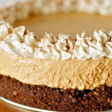 A slice of cozy no-bake pumpkin silk pie on a decorative plate.