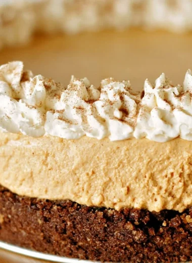 A slice of cozy no-bake pumpkin silk pie on a decorative plate.