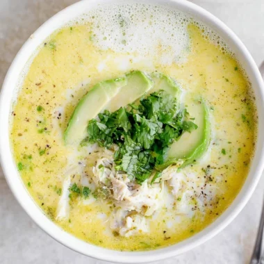 Bowl of creamy white chicken chili topped with cilantro and jalapeños.