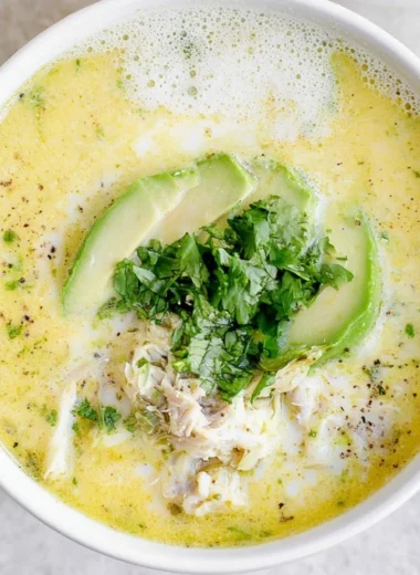 Bowl of creamy white chicken chili topped with cilantro and jalapeños.