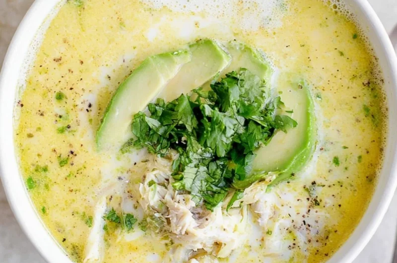 Bowl of creamy white chicken chili topped with cilantro and jalapeños.