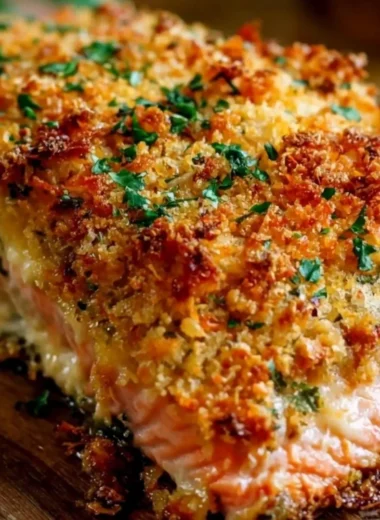 Crispy Parmesan Crusted Baked Salmon on a plate with herbs