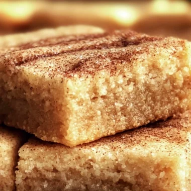 Chewy snickerdoodle cookie bars topped with cinnamon sugar.