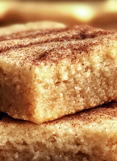 Chewy snickerdoodle cookie bars topped with cinnamon sugar.
