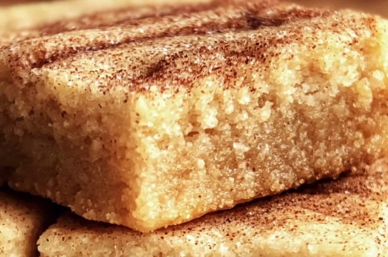 Chewy snickerdoodle cookie bars topped with cinnamon sugar.
