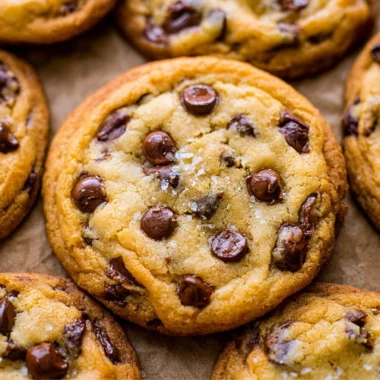 Freshly baked chocolate chip cookies cooling on a wire rack.