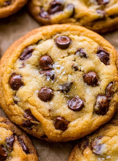 Freshly baked chocolate chip cookies cooling on a wire rack.