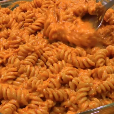 Delicious high-protein creamy tomato pasta dish garnished with fresh herbs
