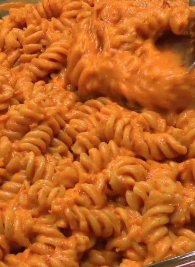 Delicious high-protein creamy tomato pasta dish garnished with fresh herbs