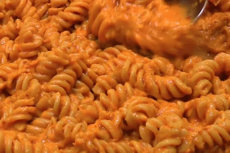Delicious high-protein creamy tomato pasta dish garnished with fresh herbs