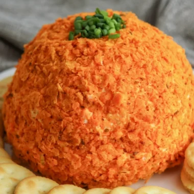 Delicious nacho cheese ball served with crackers and veggies