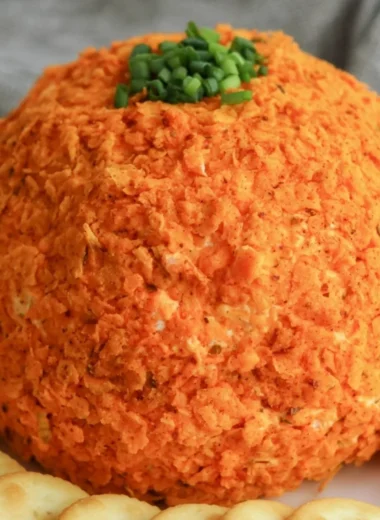 Delicious nacho cheese ball served with crackers and veggies