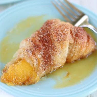 Delicious Peach Cobbler Dumplings served warm with a scoop of ice cream