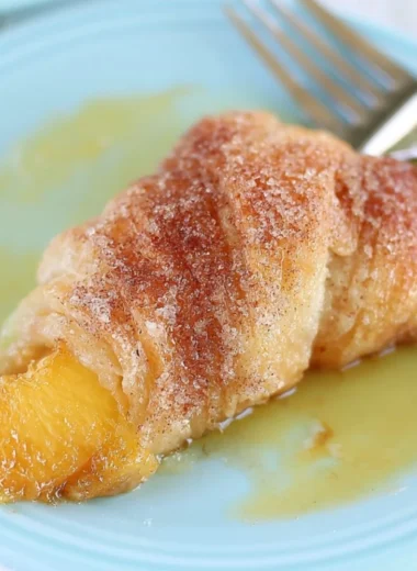 Delicious Peach Cobbler Dumplings served warm with a scoop of ice cream