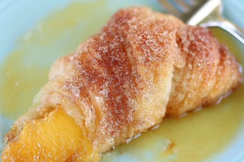 Delicious Peach Cobbler Dumplings served warm with a scoop of ice cream