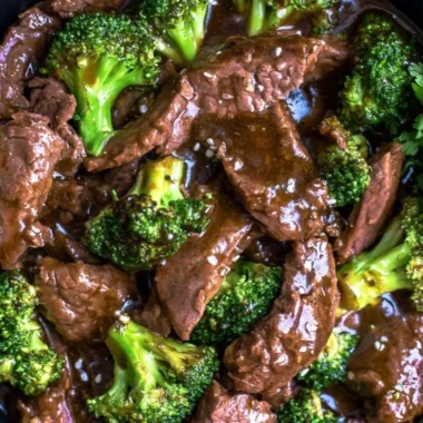 Delicious slow cooker beef and broccoli served with rice on a plate.